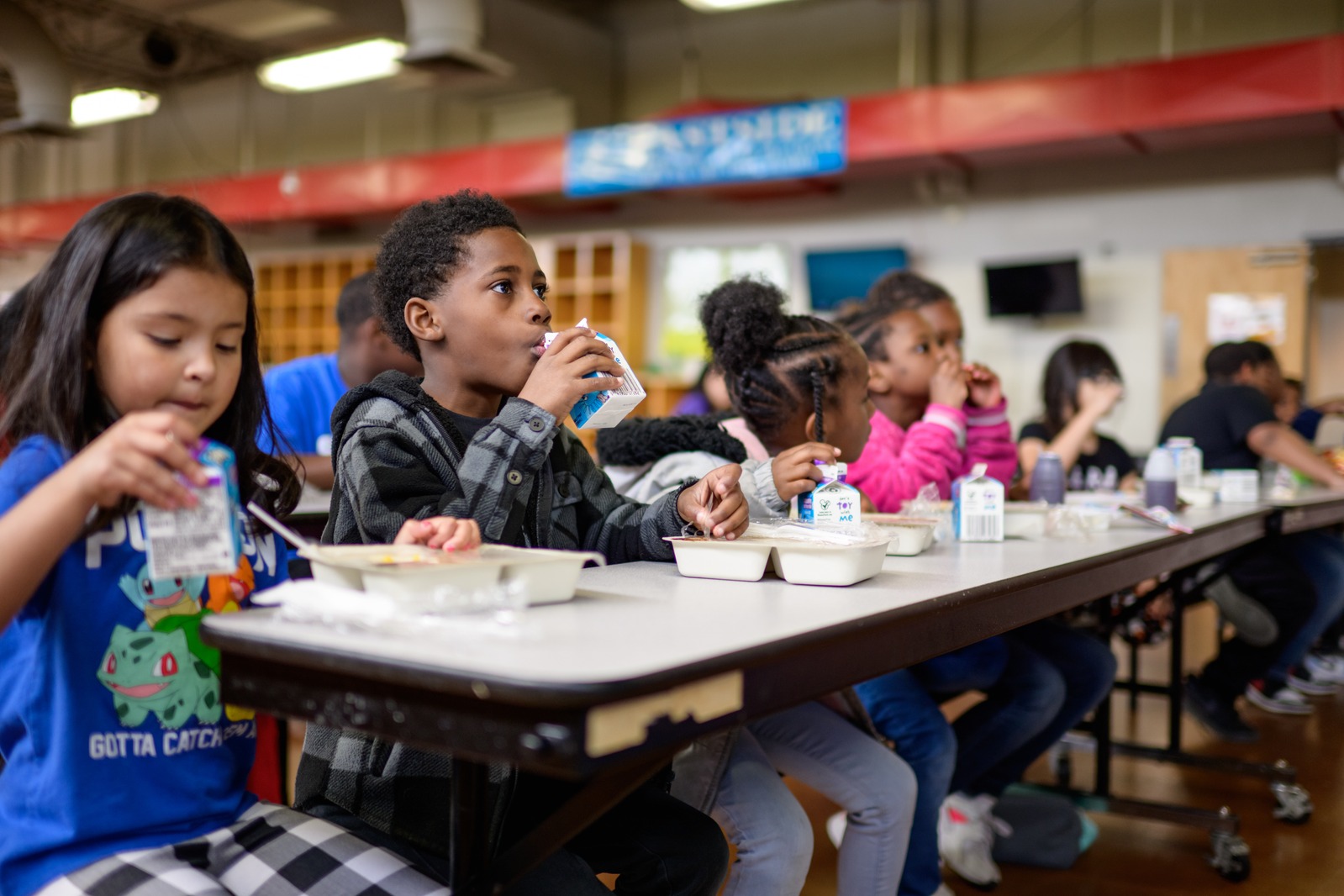 Club members eating a meal together at a long table in the Club